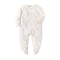 Cream Spots print baby romper with a zip from one ankle to the neck, covered feet and fold-over cuffs, laid flat