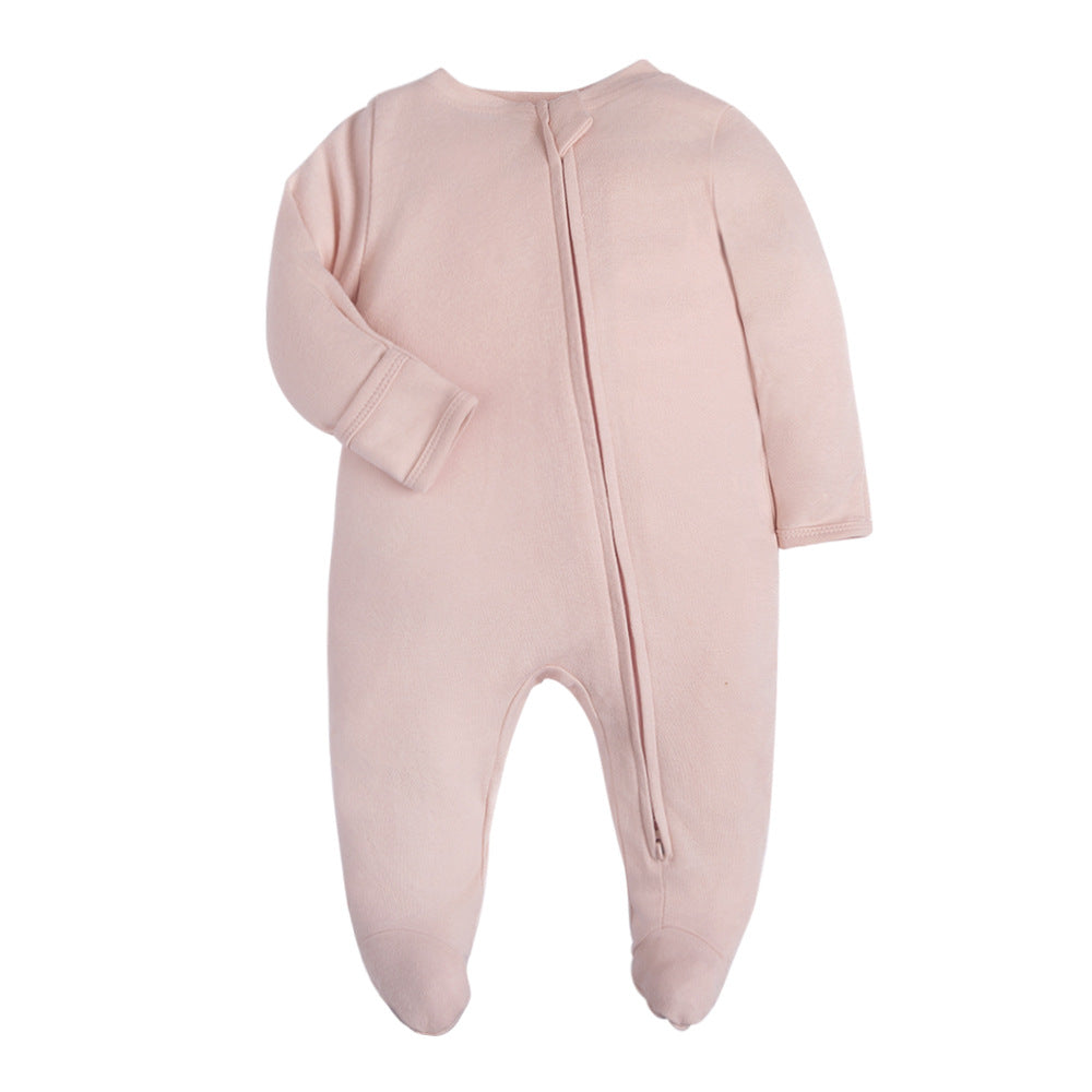 Plain dusty pink baby romper with a zip from one ankle to the neck, covered feet and fold-over cuffs, laid flat