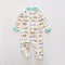 Cream digger zip baby sleepsuit with covered feet and a snap tab at the neck, laid flat