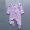 Lilac zip baby sleepsuit with a purple bear-head print, covered feet and fold-over hand cuffs, laid flat