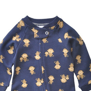 Close-up of the navy monkey print, the cotton jersey and the top of the zip