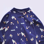 Close-up of the navy rocket print, the cotton jersey and the top of the zip