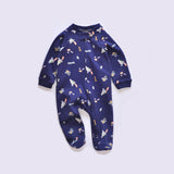 Navy rocket zip baby sleepsuit with covered feet and a snap tab at the neck, laid flat