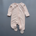 Peach floral zip baby sleepsuit with covered feet and fold-over hand cuffs, laid flat