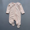 Peach floral zip baby sleepsuit with covered feet and fold-over hand cuffs, laid flat