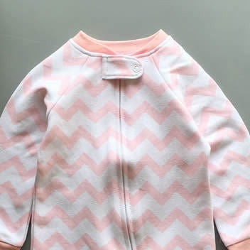 Close-up of the pink zigzag print, the cotton jersey and the top of the zip