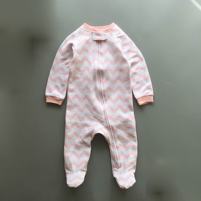 Pink zigzag zip baby sleepsuit with covered feet and a snap tab at the neck, laid flat