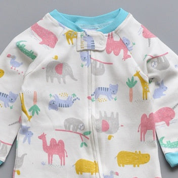 Close-up of the white animal park print, the cotton jersey and the top of the zip