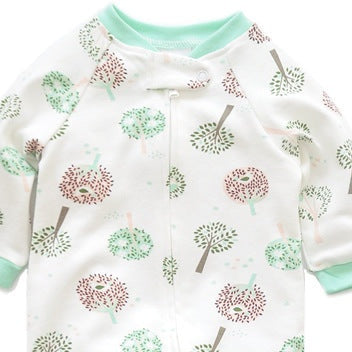 Close-up of the white tree print, the cotton jersey and the top of the zip